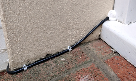 ethernet network cable installation through window frame for internet connection sharing in basement flat in welwyn hertfordshire