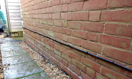 external cat5e ethernet cabling installed along wall of house in hitchin hertfordshire