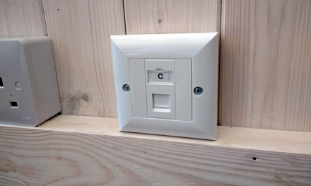 cat5e ethernet rj45 wall box in summerhouse on wood wall