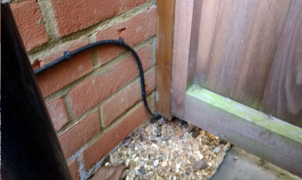 external cat5e ethernet cabling going under gate in garden hertfordshire