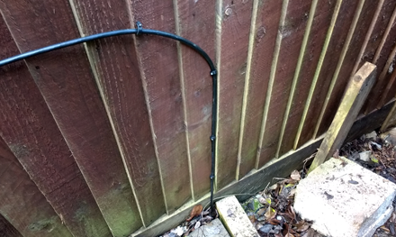 external cat5e ethernet cabling tacked to fence in garden hertfordshire